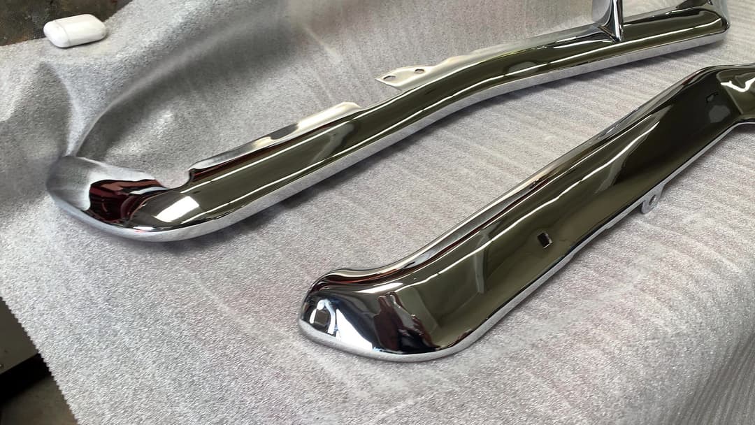 Two freshly chromed bumper trim pieces
