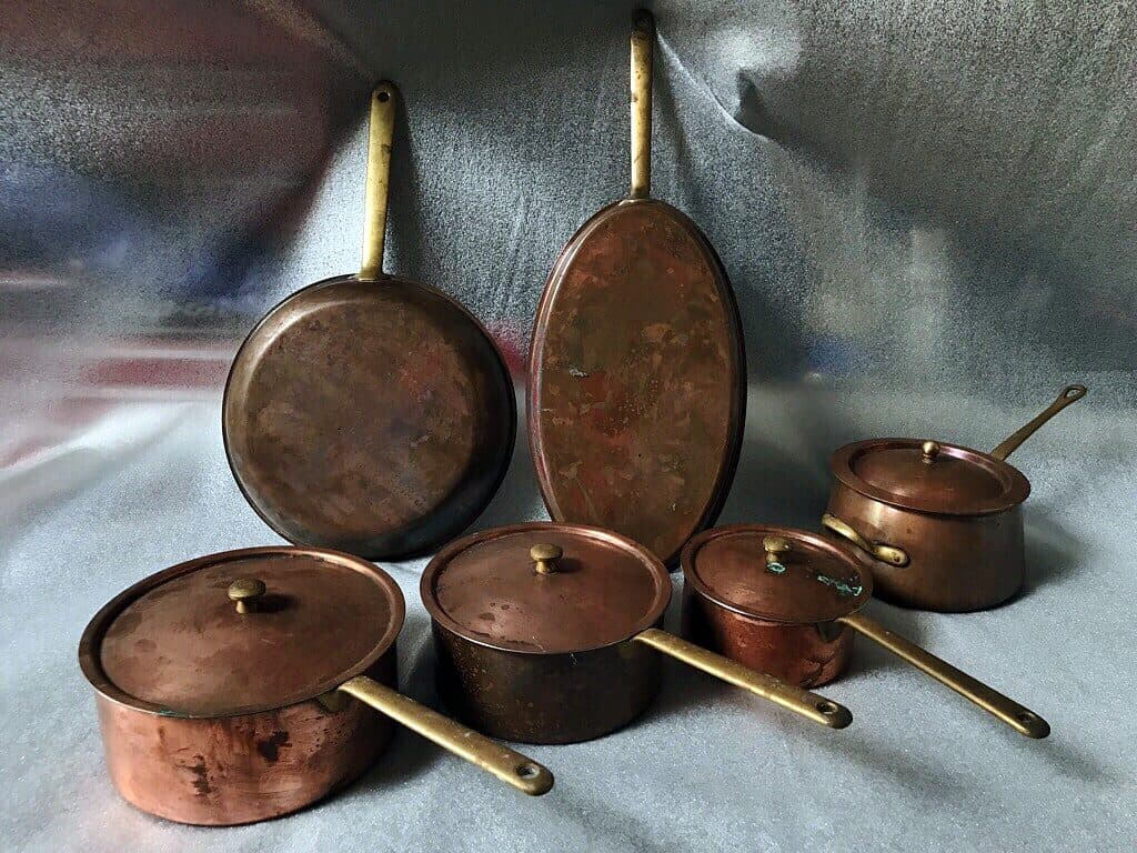 Antique copper pans with brass handles