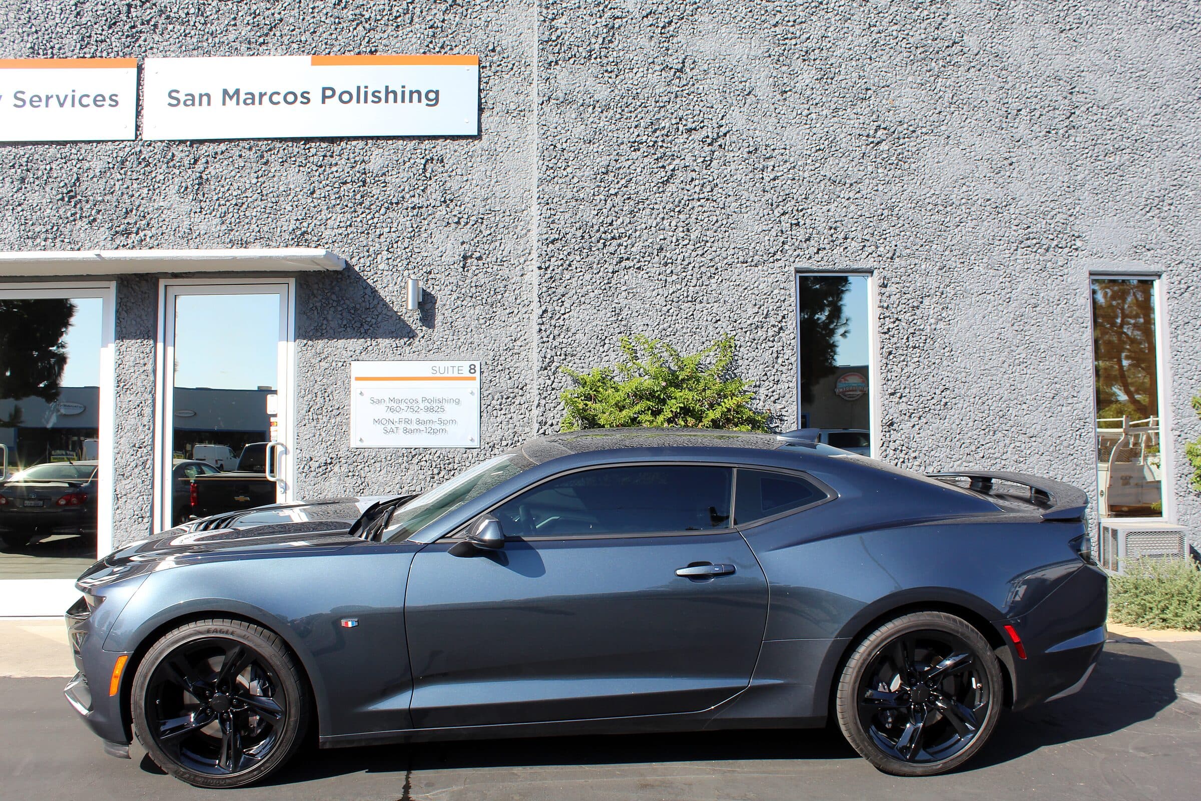 The San Marcos shop front with a customer car outside